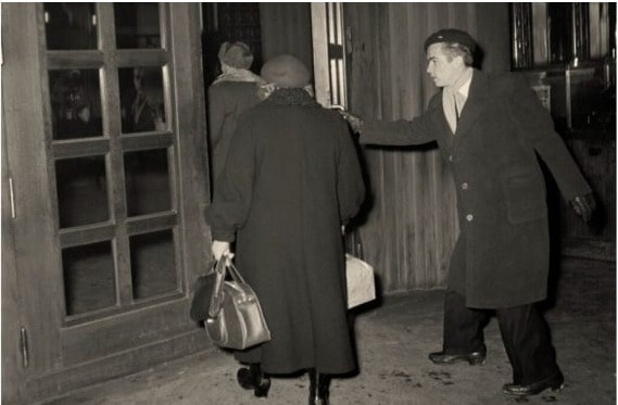 man holding door in 1950s