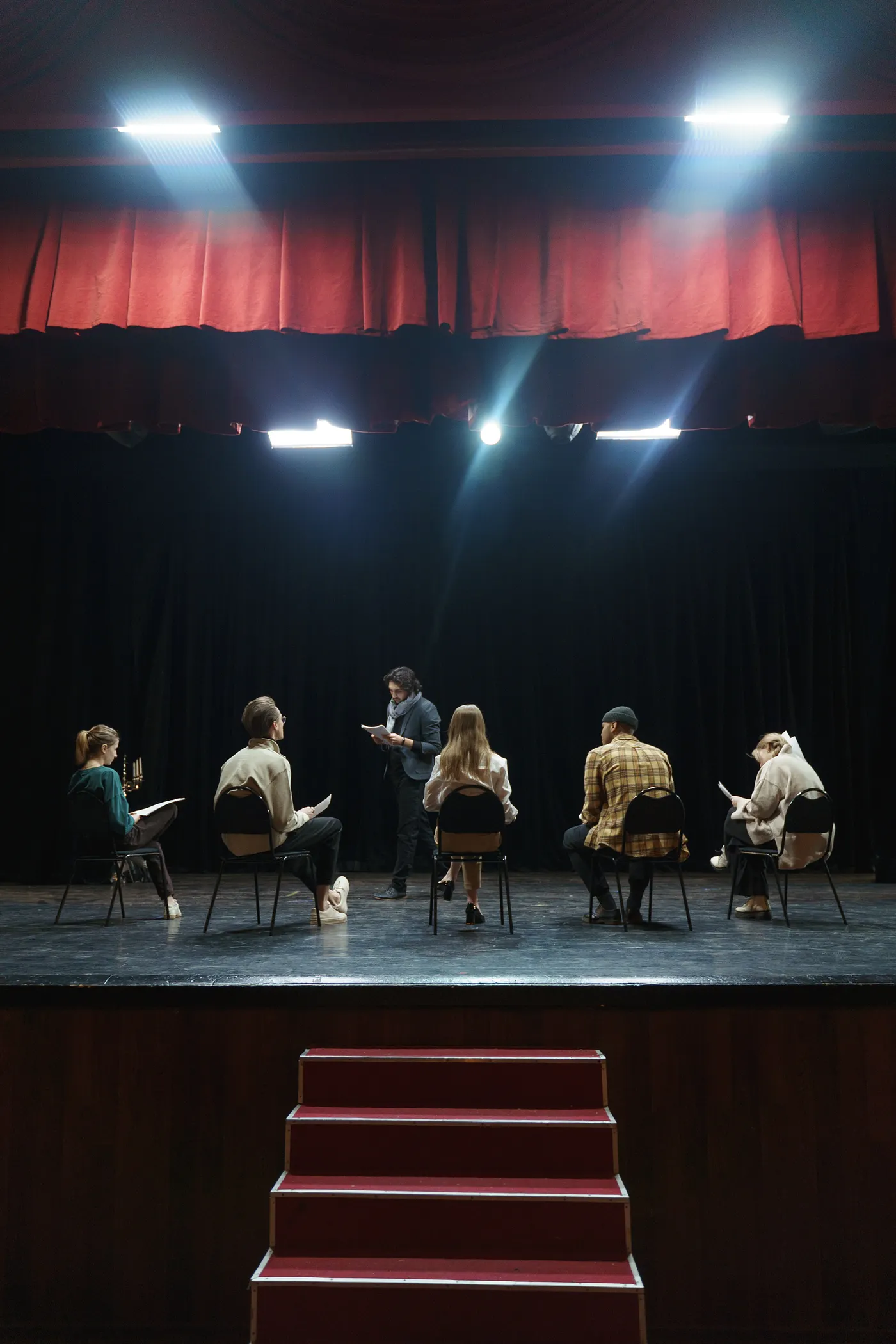 Group of People Sitting on Chair on Stage