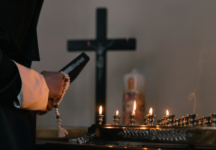 Person Holding Holy Book and Prayer Beads