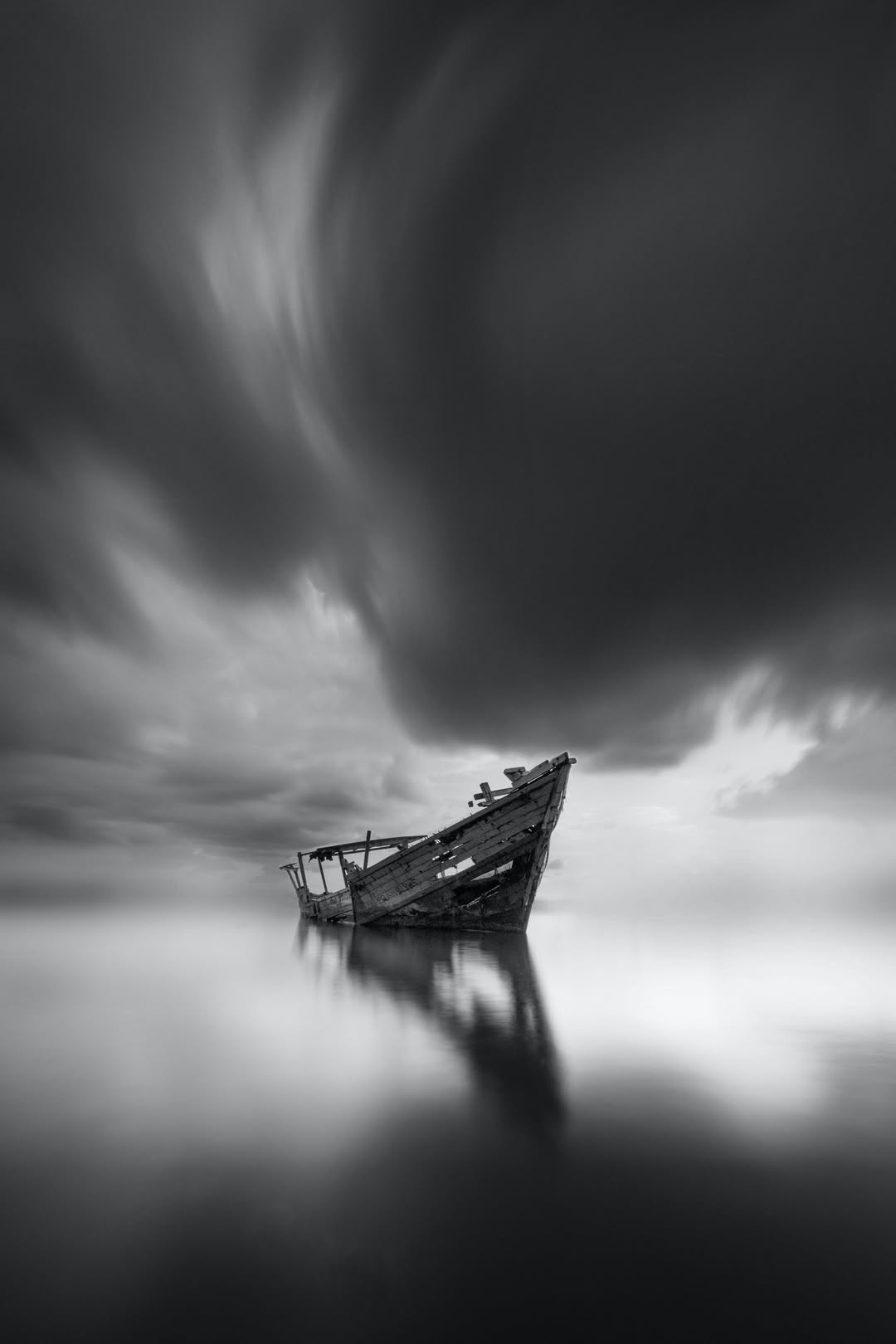 Dramatic Sky over a Shipwreck Abandoned on a Lake