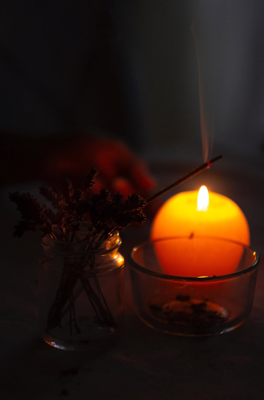 Close-Up Photo of Lighted Incense Stick Near Candle