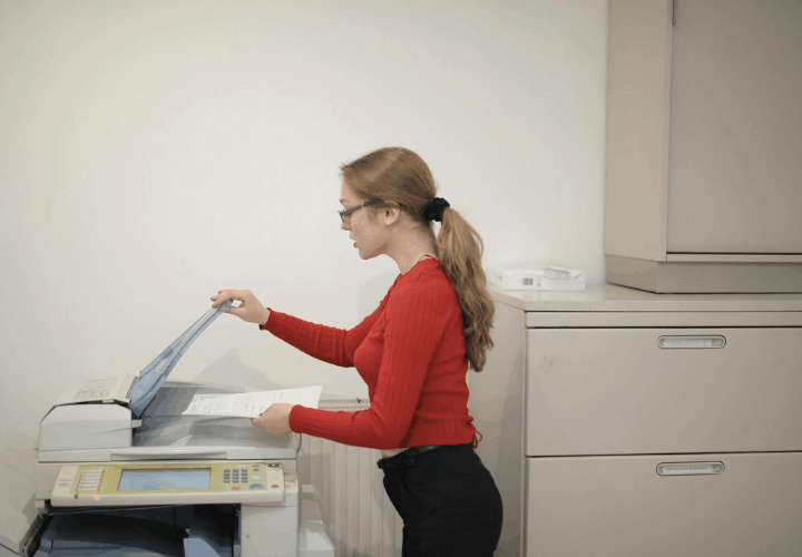 Woman working with a copy machine